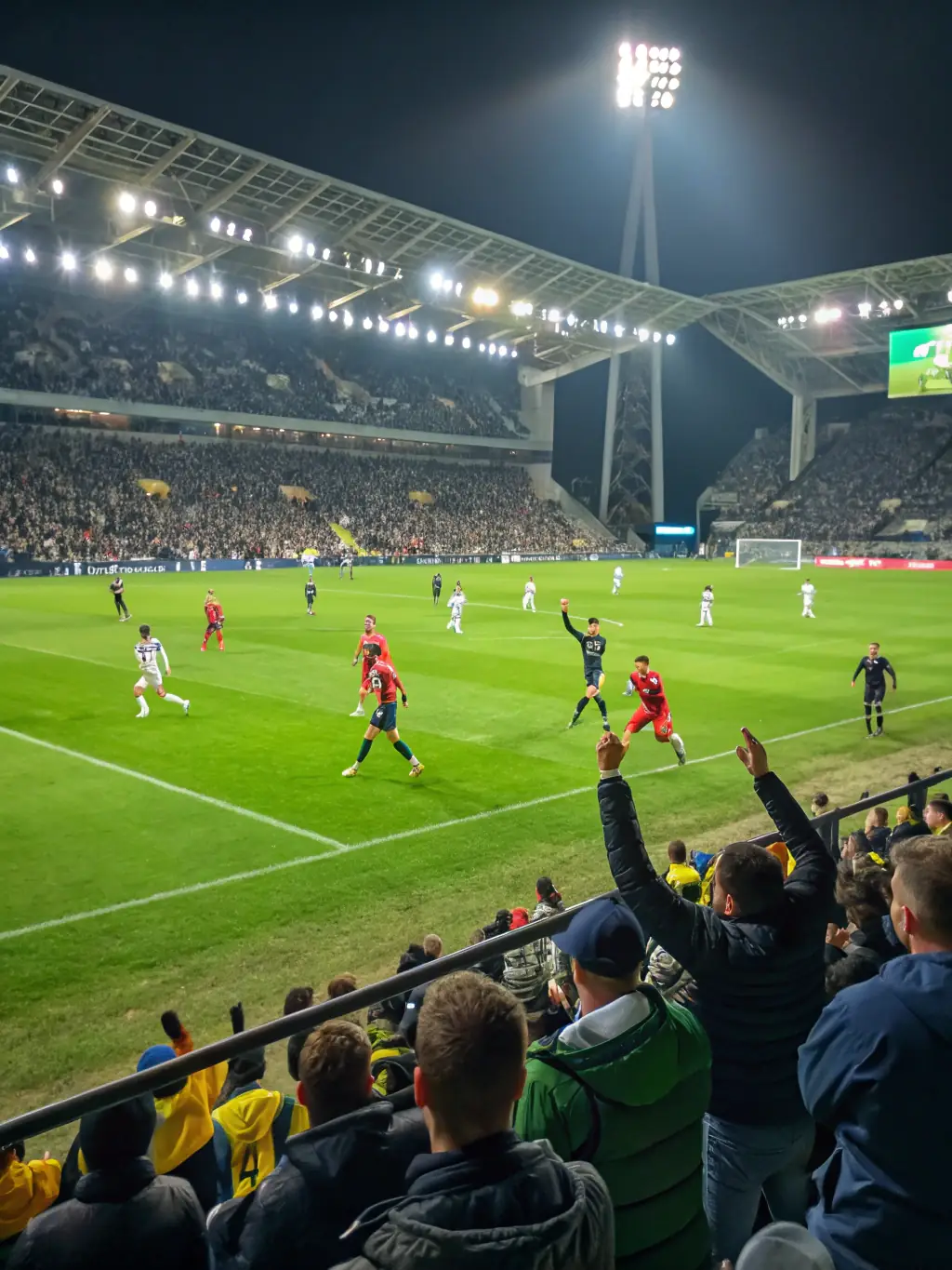 An image of a football match in progress at Turf City Kenya during the evening, highlighting the bright and effective lighting system.